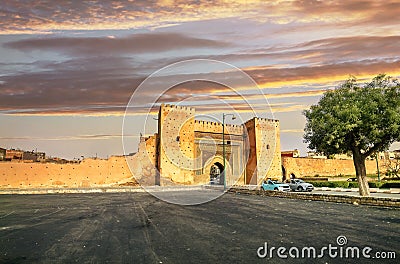 Town wall and gate Bab el-Khamis in medina of Meknes at sunset. Morocco Stock Photo