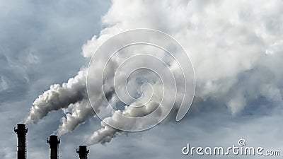 Toxic emissions of toxic gases into the atmosphere, industrial air pollution. Dark chimneys blowing huge billows of Stock Photo