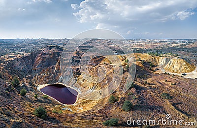 Toxic lake in abandoned open pit copper mine and waste heaps near Kampia, Cyprus Stock Photo