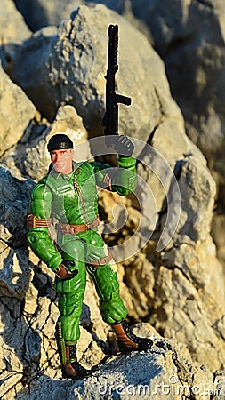 Toy action figure of GI Joe called Chief Torpedo standing on coastal rocks Editorial Stock Photo