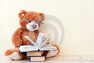 Toy bear reading an interesting book, showing that even read toys. the concept of baby learning Stock Photo