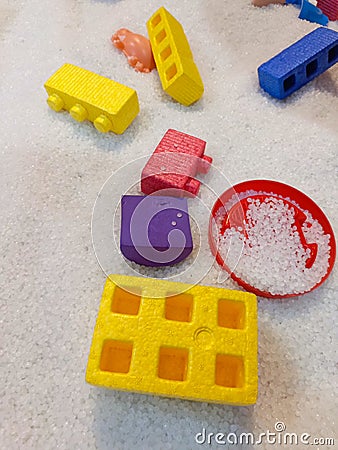 Toy blocks on artificial sand in a children& x27;s play area Stock Photo