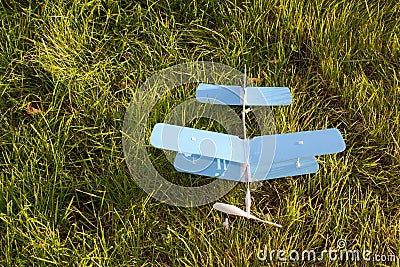 Toy blue plane airplane on green grass Stock Photo