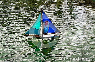 Toy Boat on Pond Stock Photo
