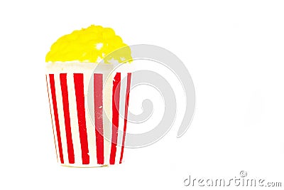 Toy bright striped glass with yellow popcorn. Stock Photo