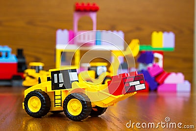 Toy bulldozer with bricks Stock Photo