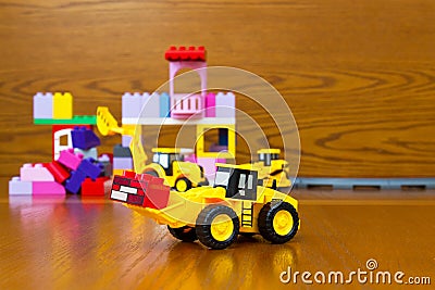 Toy bulldozer with bricks Stock Photo