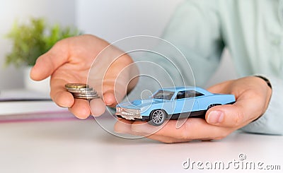 Toy car in hand, keys and money on table. Car loan, money, car insurance concept Stock Photo