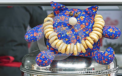 Toy cat with bagels on a metal dish Stock Photo