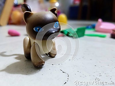 A Toy Cat Standing Among Other Toys Stock Photo