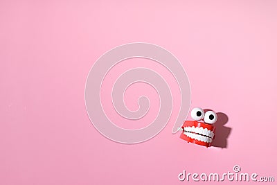 Toy clockwork jaws on a pink background with a place for text. Happy Halloween. A place to copy. Flat position, top view Stock Photo