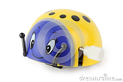 Toy clockwork yellow ladybird with blue face Stock Photo