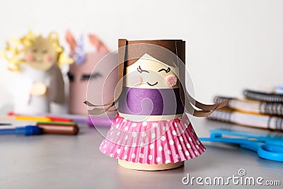 Toy doll made of toilet paper hub on table Stock Photo