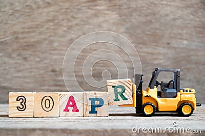 Toy forklift hold block R to word 30apr on wood background Concept for calendar date 30 in month april Stock Photo