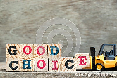 Toy forklift hold letter block E to complete word good choice on Stock Photo