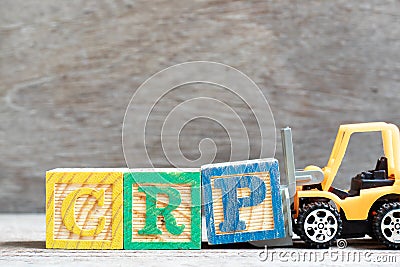 Toy forklift hold block P to complete word CRP abbreviation of C-Reactive Protein Test on wood background Stock Photo