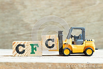 Toy forklift hold block to complete word Alphabet letter in word CFC abbreviation of Chlorofluorocarbon on wood Stock Photo