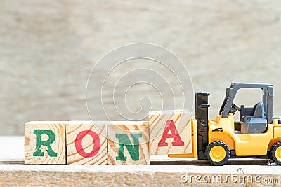 Toy forklift hold block a to complete word RONA Abbreviation of Return on net assets on wood background Stock Photo