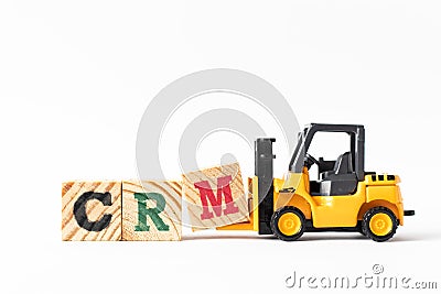 Toy forklift hold wood block M to complete word CRM Abbreviation of Customer Relationship Management on white background Stock Photo