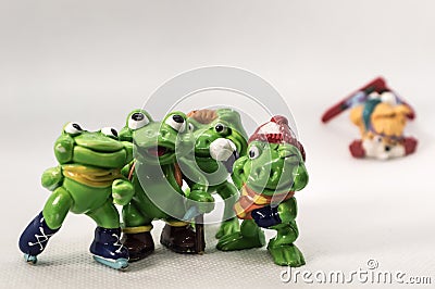 Toy frogs and skiing dog Stock Photo