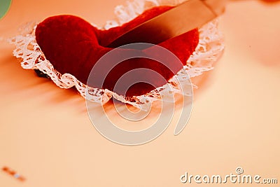 Toy heart with knife, Hit in the heart. Stock Photo