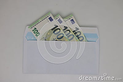 Toy house. banknotes in a yellow envelope on a light background. envelope with banknotes. close-up of an envelope with Stock Photo