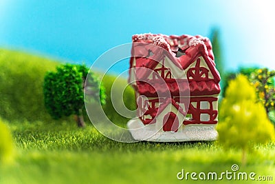 A toy house on green grass in fictional world Stock Photo