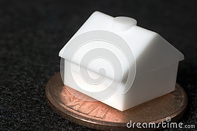 Toy house on penny Stock Photo