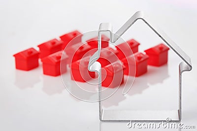 Toy houses and metallic shape of a house Editorial Stock Photo