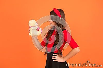 Toy is me. Little kid hold teddy bear brown background. Small kid play with soft toy. Kid gift or present. Toy store Stock Photo