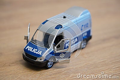 Toy model Polish Police van on a wooden surface. Editorial Stock Photo