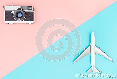 Toy plane and camera on pink and blue background Stock Photo