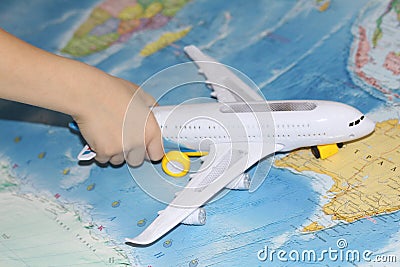 The toy plane flies by the geographical map Stock Photo