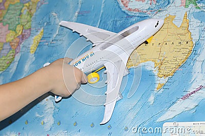 The toy plane flies by the geographical map Stock Photo