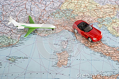 Toy plane and red car on the geographical map of Europe. Travel route planning concept Stock Photo