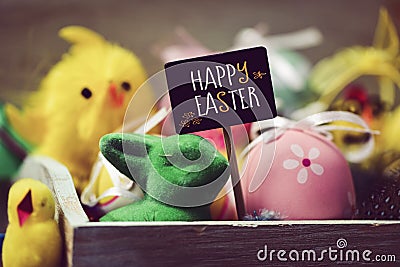 Toy rabbit and chicks, easter eggs and text happy easter Stock Photo