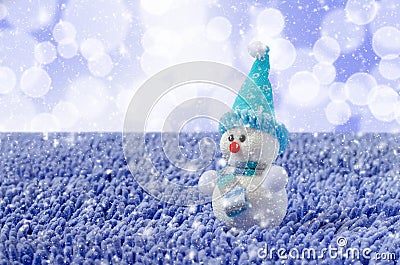 Toy Snowman with hat and scarf. Falling snow Stock Photo