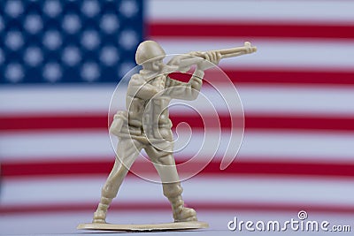 Toy soldier in front of American flag with desert brown color Stock Photo