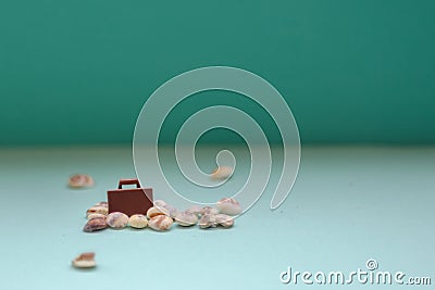 Toy suitcase model on a blue background. A trip to the sea by airplane on vacation. Weekend by car. Travel concept Stock Photo