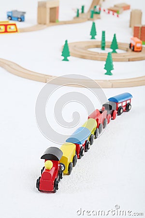 Toy train with cars and wooden toy railway with spruces Stock Photo