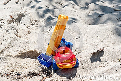 Toy truck with a boom in the wet sand. Summer holidays at sea. Special miniature. Stock Photo