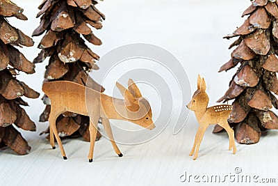 Toy wooden deer and pine cones in the form of christmas trees Stock Photo