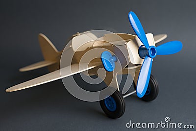 Toy wooden plane with blue propeller Stock Photo