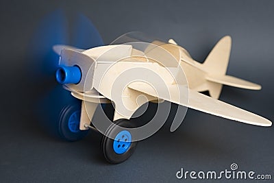 Toy wooden plane with rotating blue propeller Stock Photo