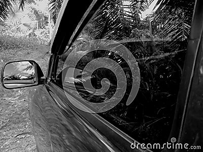 Toyota car side mirror on a classic, with black side window of pickup truck. Editorial Stock Photo