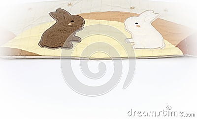 Toys for babies. Soft book with two rabbits. Baby background. Stock Photo