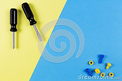 Toys background. Kids construction toys tools on blue and yellow background. Top view Stock Photo