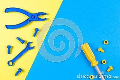 Toys background. Kids construction toys tools on blue and yellow background. Top view Stock Photo