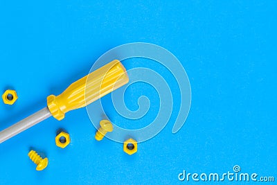 Toys background. Kids construction toys tools on light blue and yellow background. Stock Photo