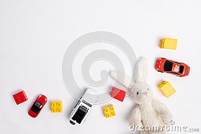 Toys constuctor and cars, top view on white background, place for text Stock Photo